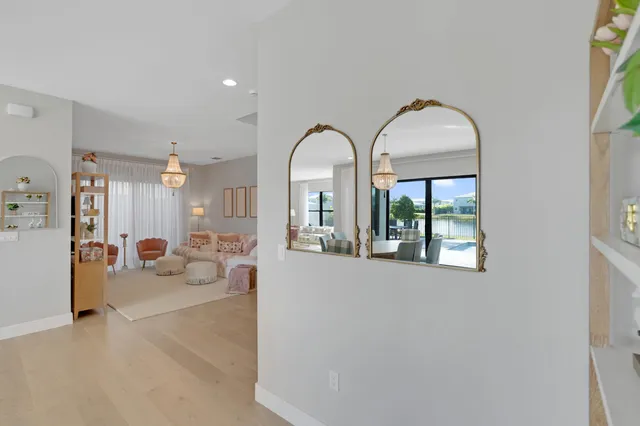 a living room with furniture and a dining table with kitchen view