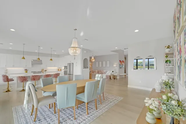 a living room with furniture a flat screen tv and a large window