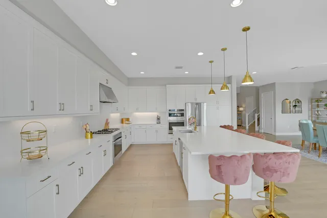 a bedroom with a large bed and a chandelier