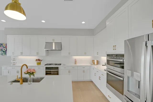 a spacious bedroom with a bed and a chandelier