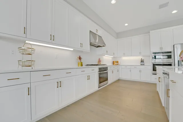a view of a dining room with furniture wooden floor and chandelier
