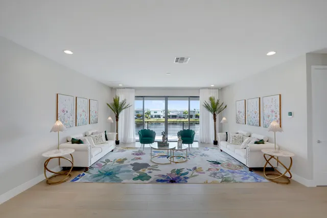 a view of house with swimming pool outdoor seating and house in the background