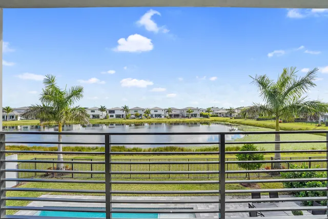 a front view of a house with swimming pool having outdoor seating