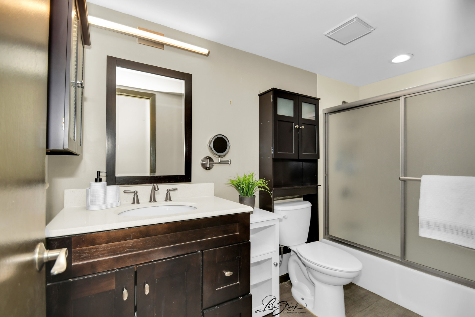 1052 Florimond Drive Elgin, IL 60123 - Photo 15 of 24 a bathroom with a sink toilet a mirror and shower