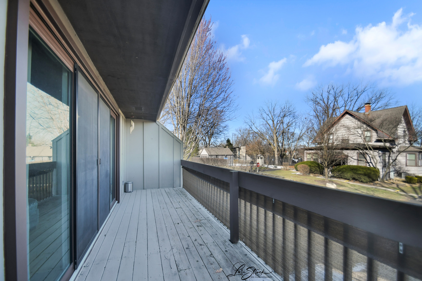 1052 Florimond Drive Elgin, IL 60123 - Photo 20 of 24 a view of a balcony with wooden floor and fence
