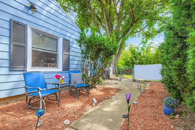 a backyard of a house with outdoor seating