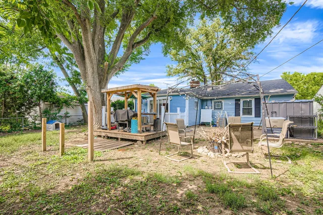 a view of a house with backyard porch and sitting area