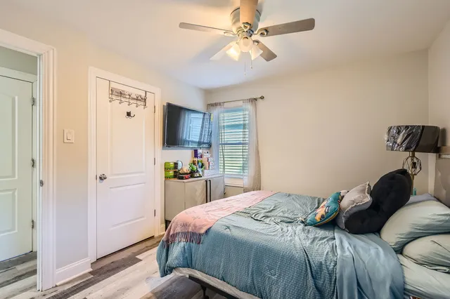 a bedroom with a bed and a chandelier