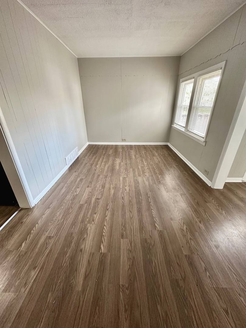 3729 Grove Avenue Berwyn, IL 60402 - Photo 14 of 20 wooden floor in an empty room with a window