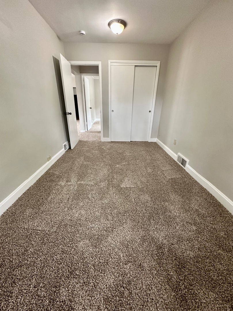 3729 Grove Avenue Berwyn, IL 60402 - Photo 9 of 20 an empty room with a mirror