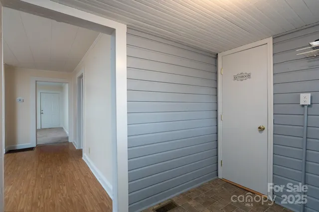 a view of hallway with wooden floor