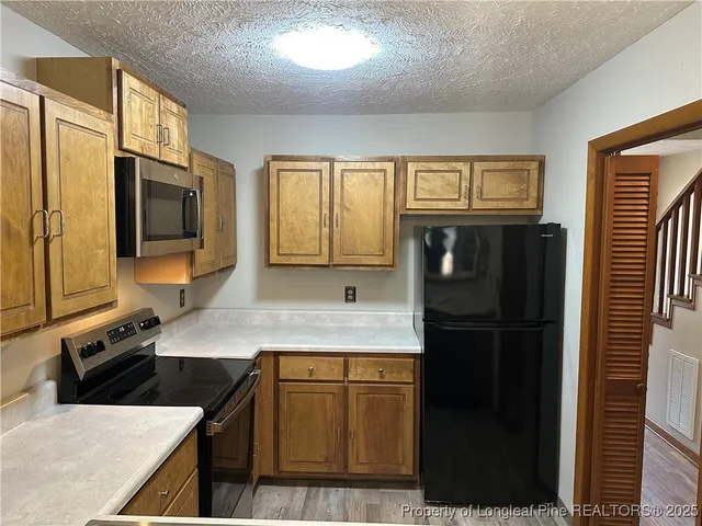 a kitchen with a refrigerator stove and sink