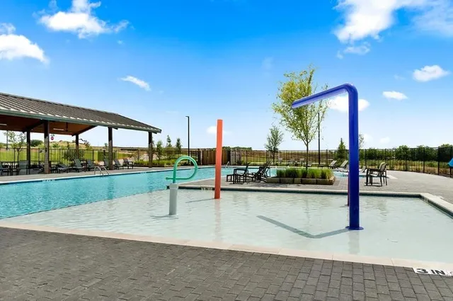 a view of a swimming pool with a patio and a garden