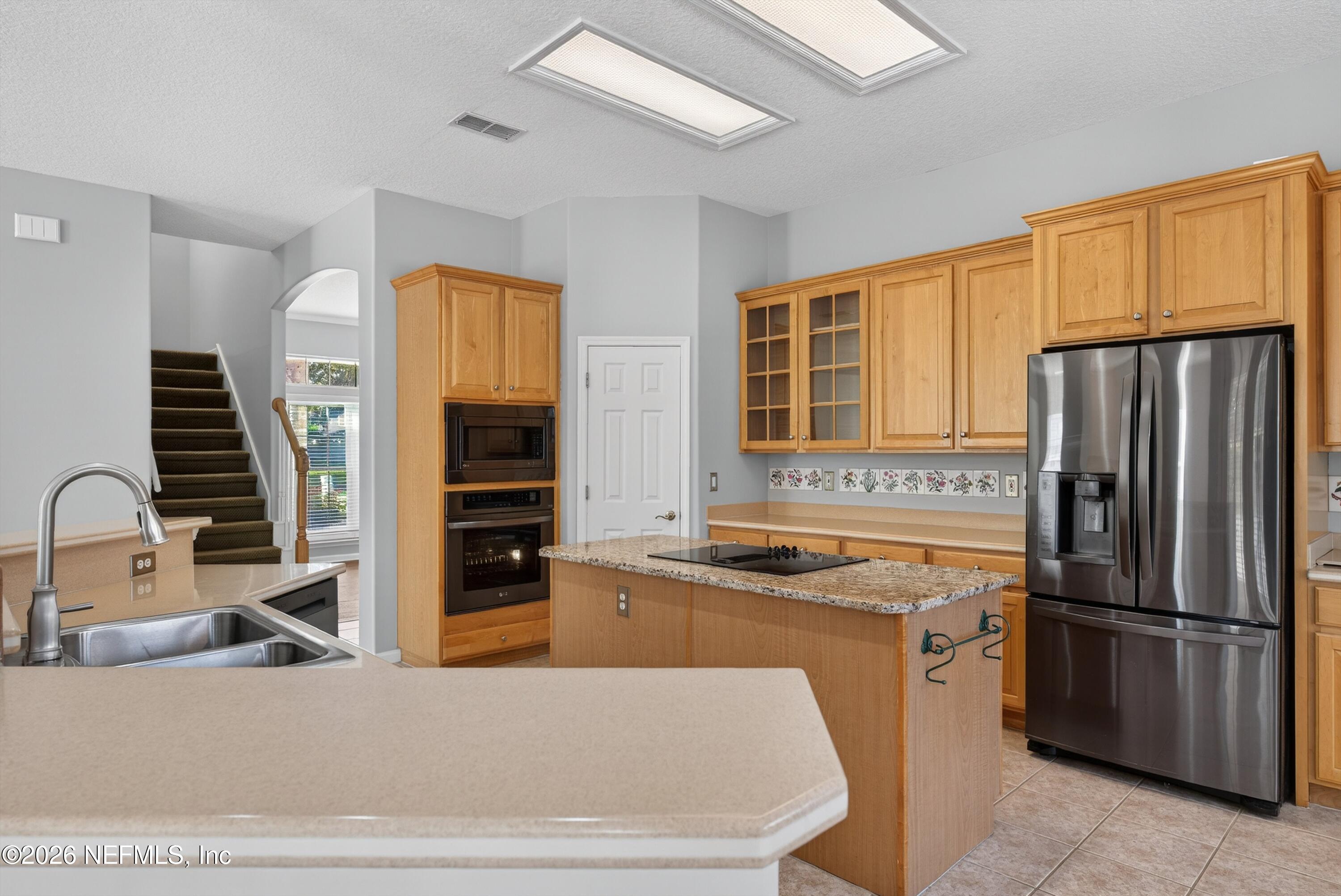 237 Strawberry Lane St. Johns, FL 32259 - Photo 13 of 28 a kitchen with stainless steel appliances a refrigerator a stove a sink and dishwasher