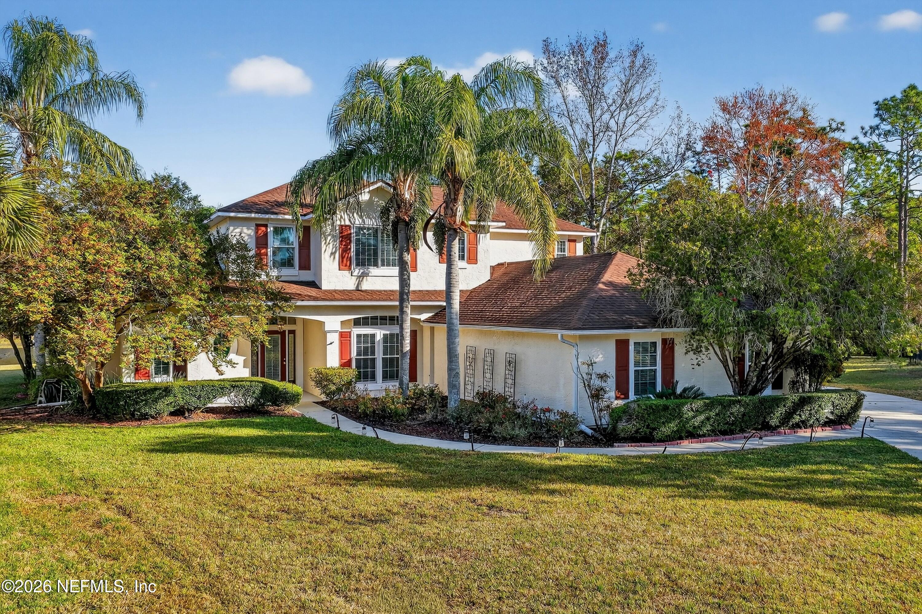 237 Strawberry Lane St. Johns, FL 32259 - Photo 2 of 28 a front view of a house with swimming pool and trees