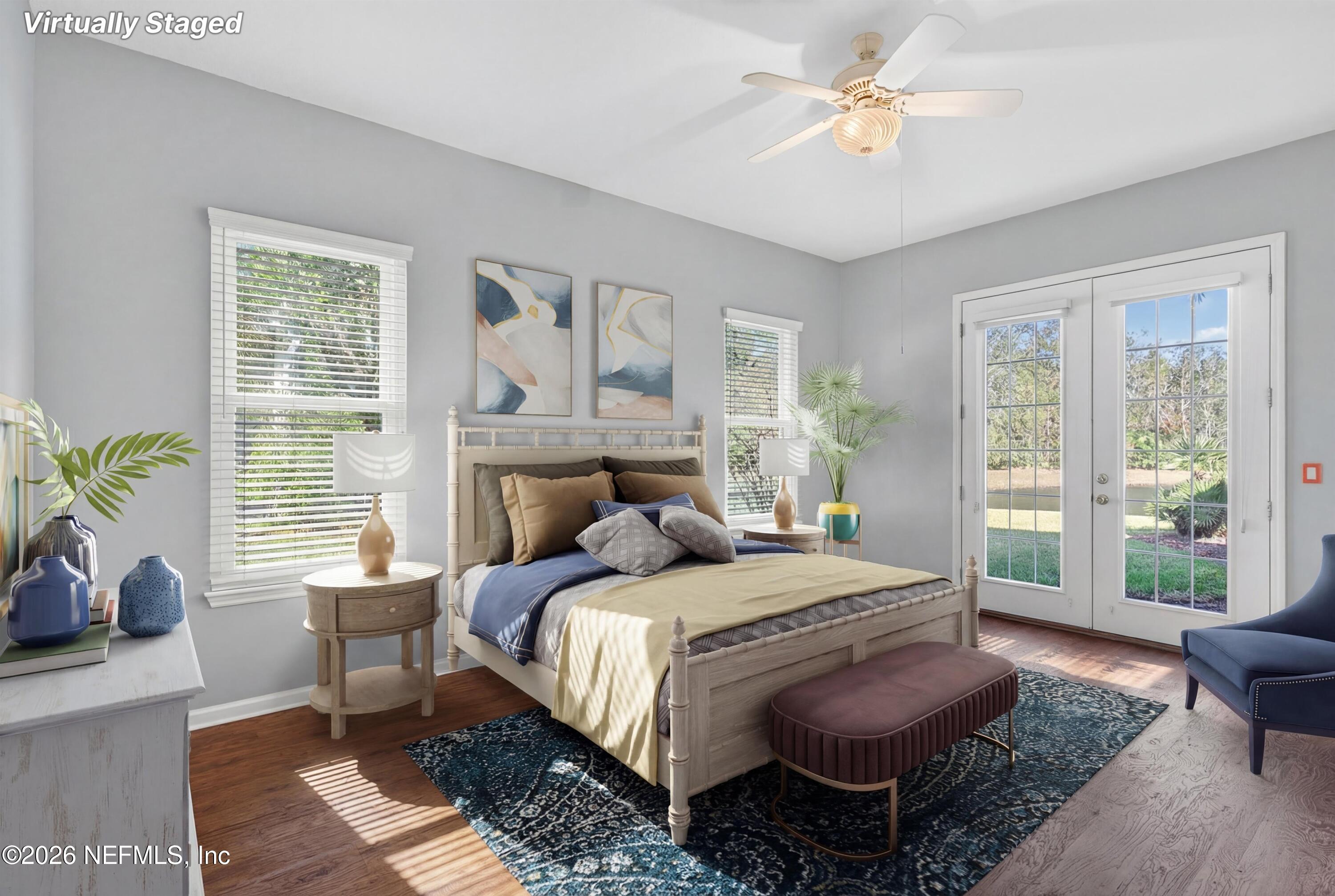 237 Strawberry Lane St. Johns, FL 32259 - Photo 7 of 28 a bedroom with a bed a couch and large windows