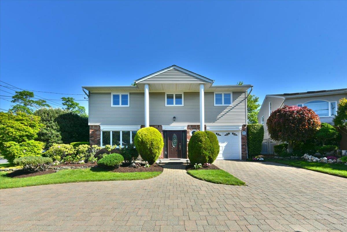 2783 Rita Court Bellmore, NY 11710 - Photo 1 of 1 Mature Landscape with Circular Stone Driveway
