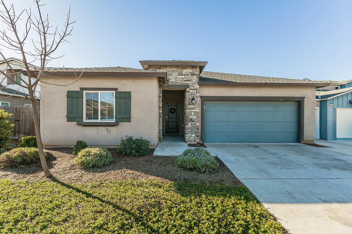 1428 Shoreside Drive Madera, CA 93637 - Photo 1 of 22 a front view of a house with a yard