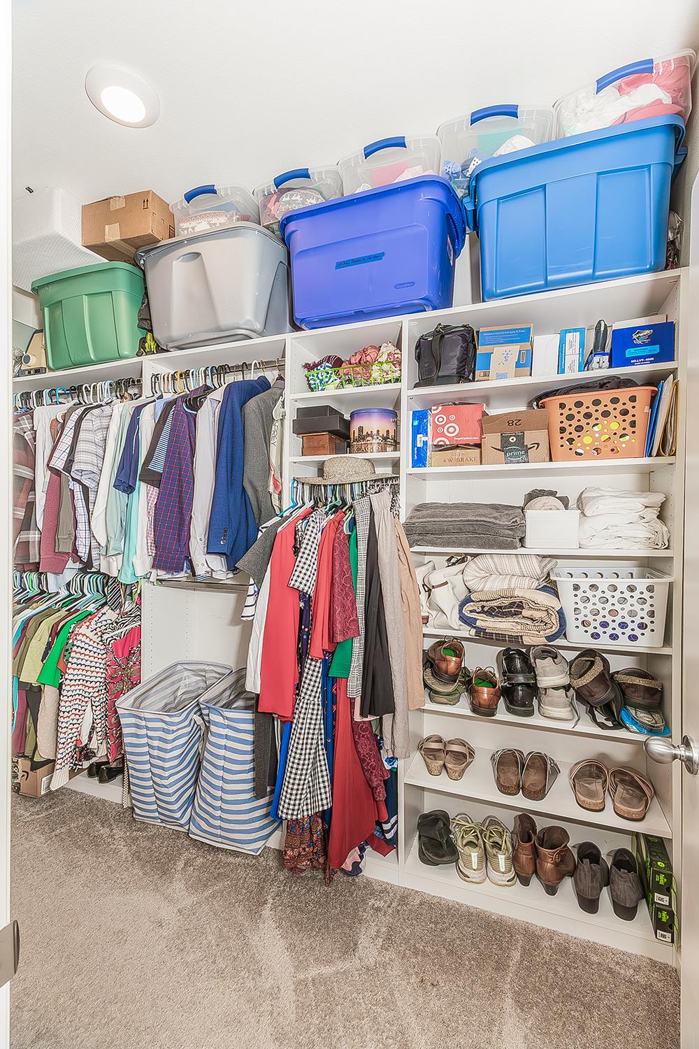 1428 Shoreside Drive Madera, CA 93637 - Photo 12 of 22 a view of walk in closet with clothes and shoes