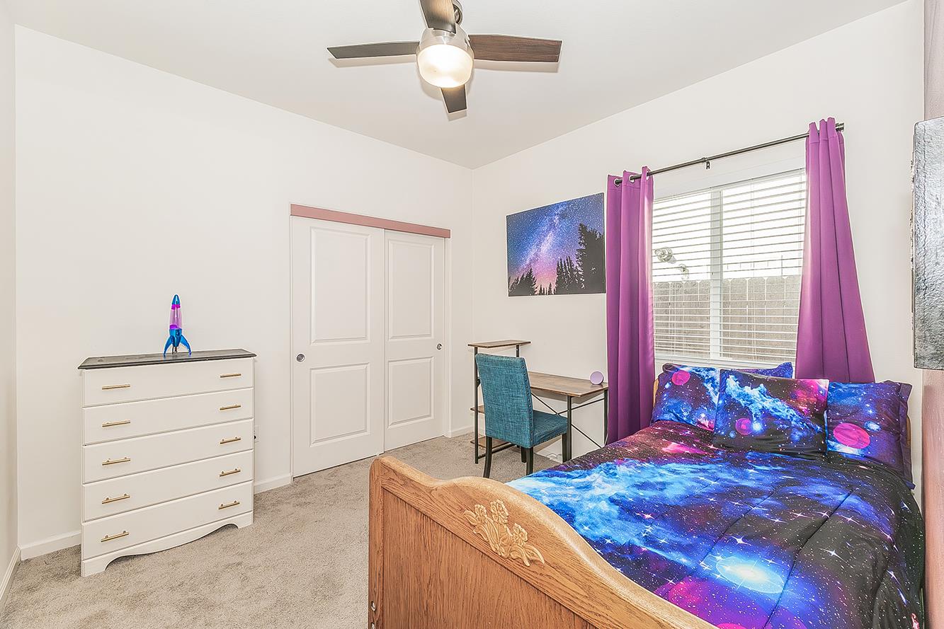 1428 Shoreside Drive Madera, CA 93637 - Photo 13 of 22 a bed room with a bed and a window