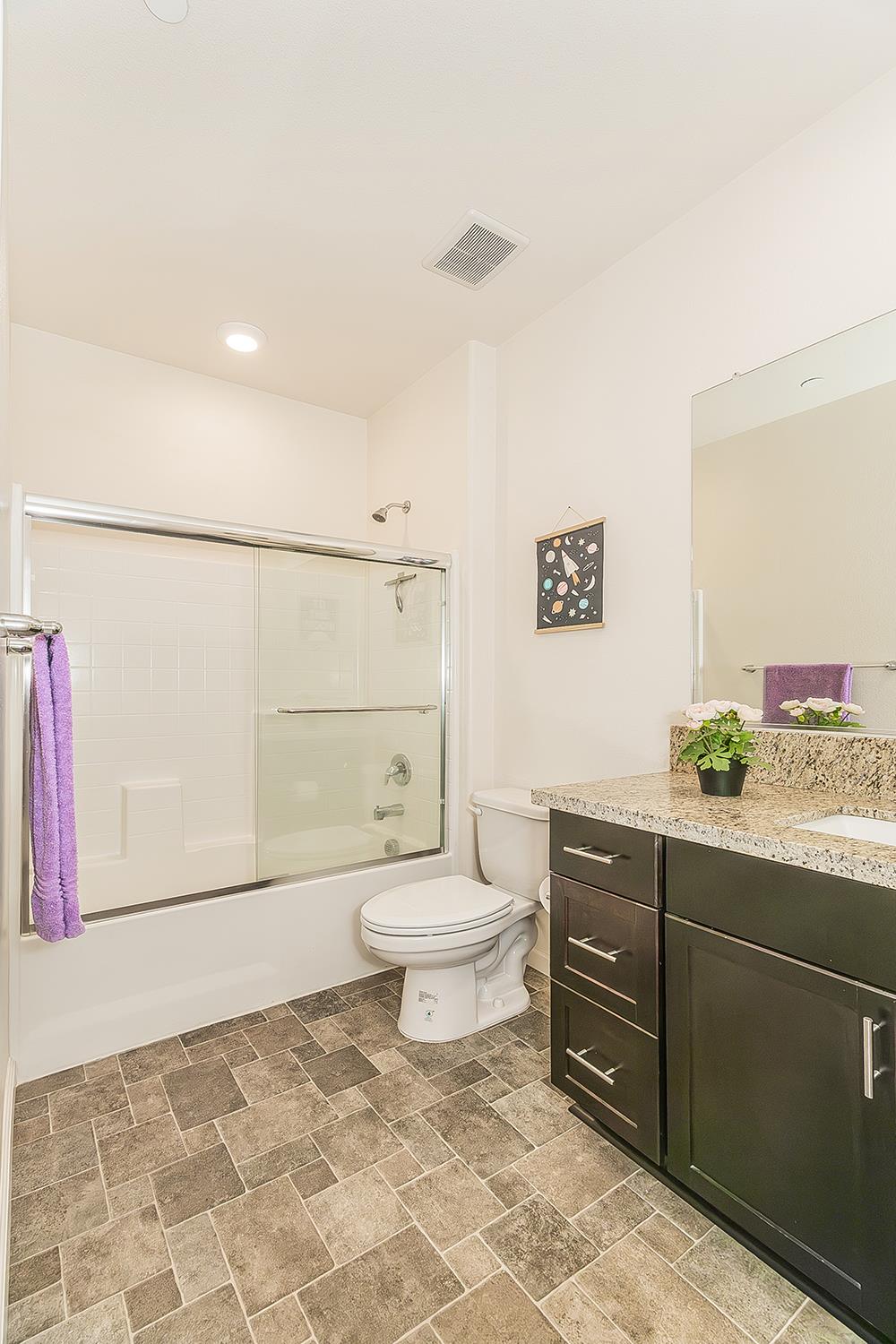 1428 Shoreside Drive Madera, CA 93637 - Photo 14 of 22 a bathroom with a granite countertop toilet sink and mirror