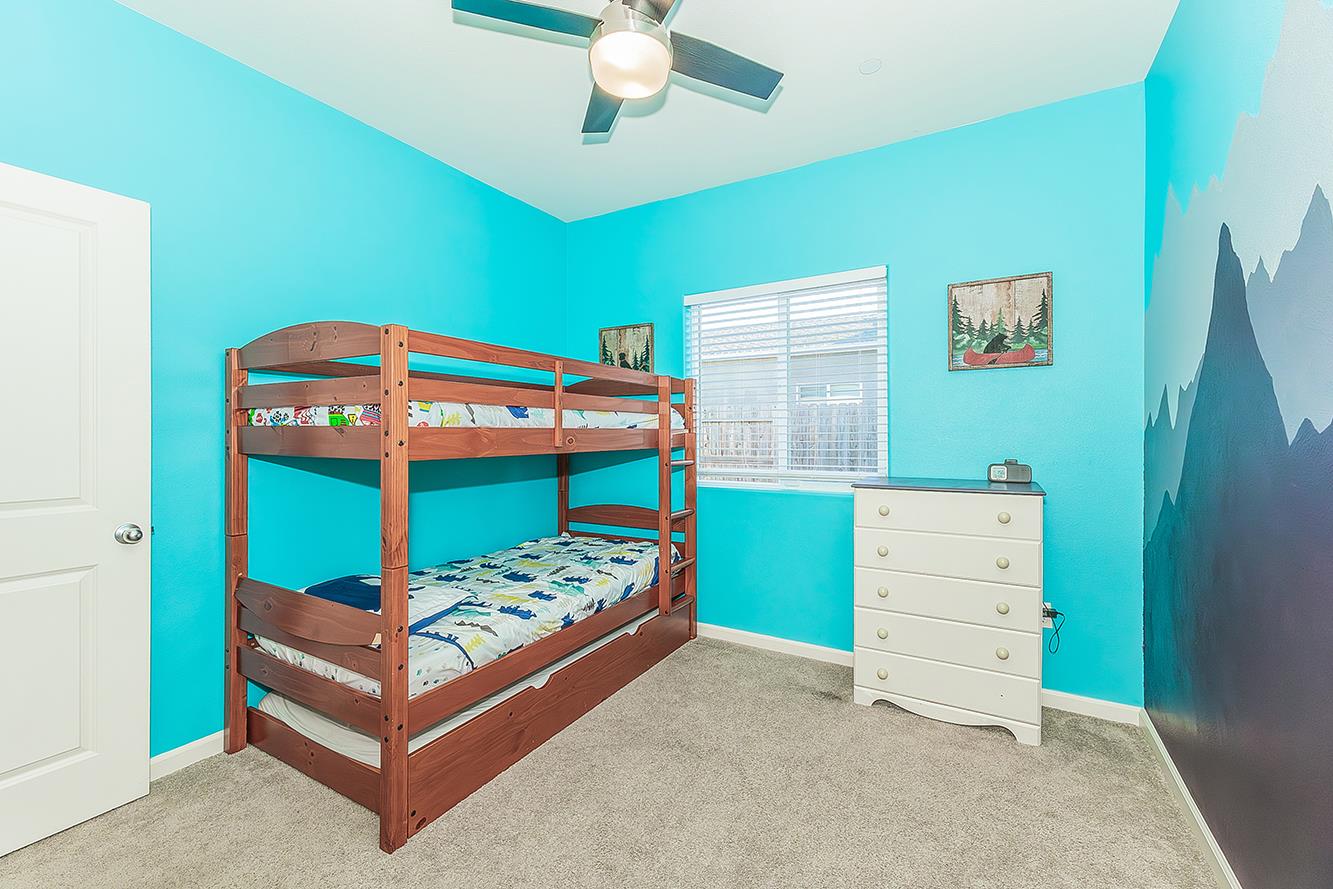 1428 Shoreside Drive Madera, CA 93637 - Photo 15 of 22 a bedroom with a bed and a dresser