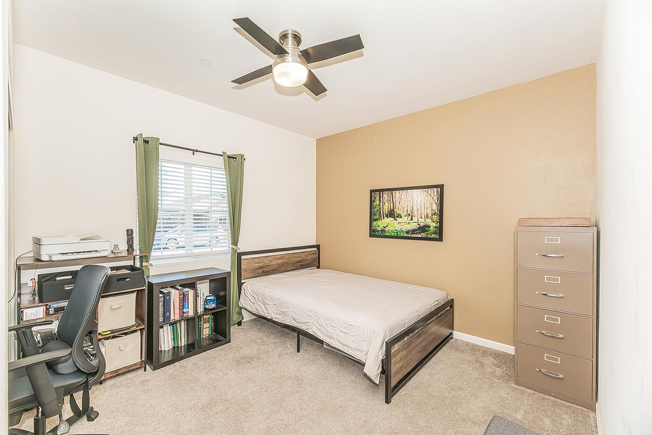 1428 Shoreside Drive Madera, CA 93637 - Photo 16 of 22 a bedroom with a bed a dresser and book shelf