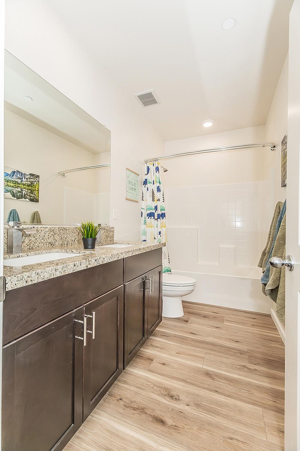 1428 Shoreside Drive Madera, CA 93637 - Photo 18 of 22 a bathroom with a sink a toilet and shower