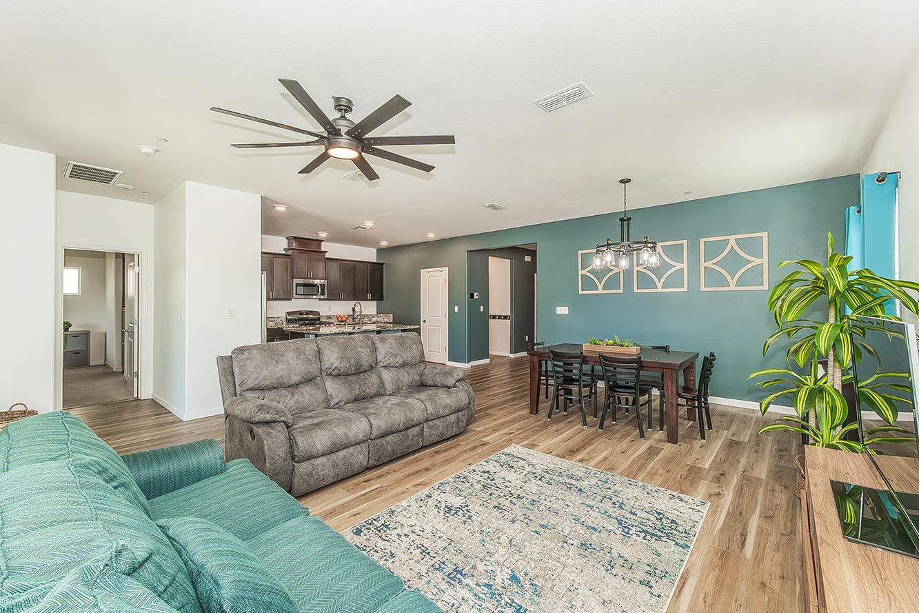 1428 Shoreside Drive Madera, CA 93637 - Photo 5 of 22 a living room with furniture dining table and a wooden floor