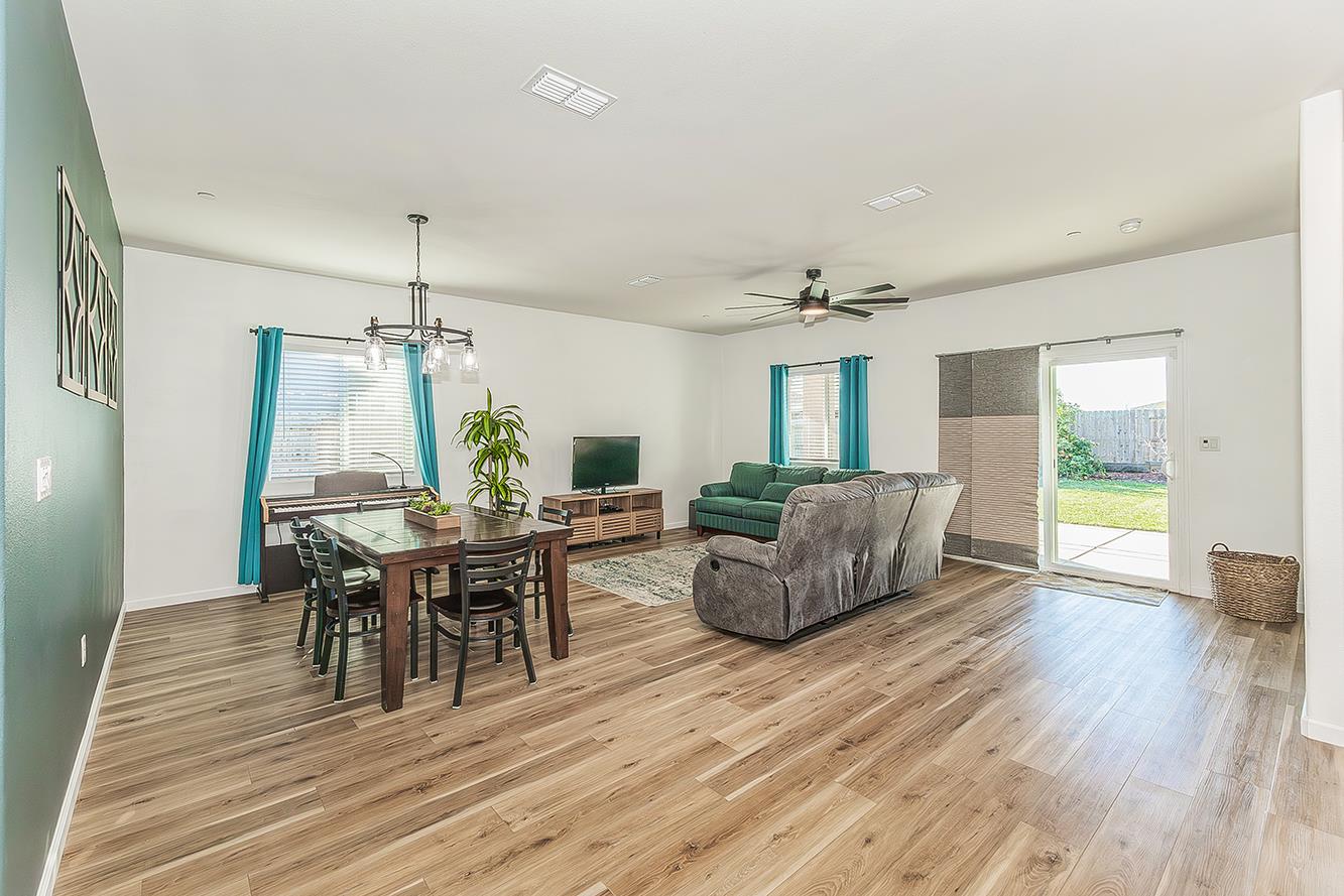 1428 Shoreside Drive Madera, CA 93637 - Photo 6 of 22 a view of a dining room with furniture and wooden floor