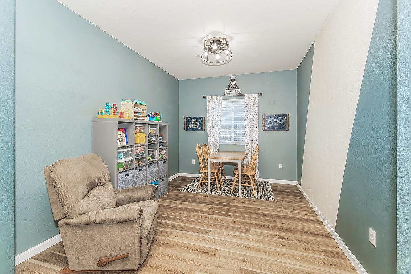 1428 Shoreside Drive Madera, CA 93637 - Photo 8 of 22 a dining room with furniture and a wooden floor