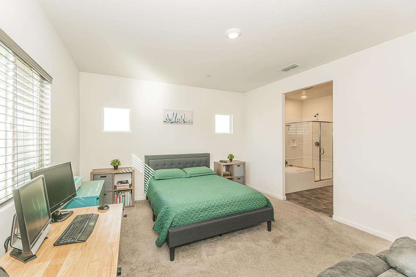 1428 Shoreside Drive Madera, CA 93637 - Photo 9 of 22 a bedroom with a bed and furniture