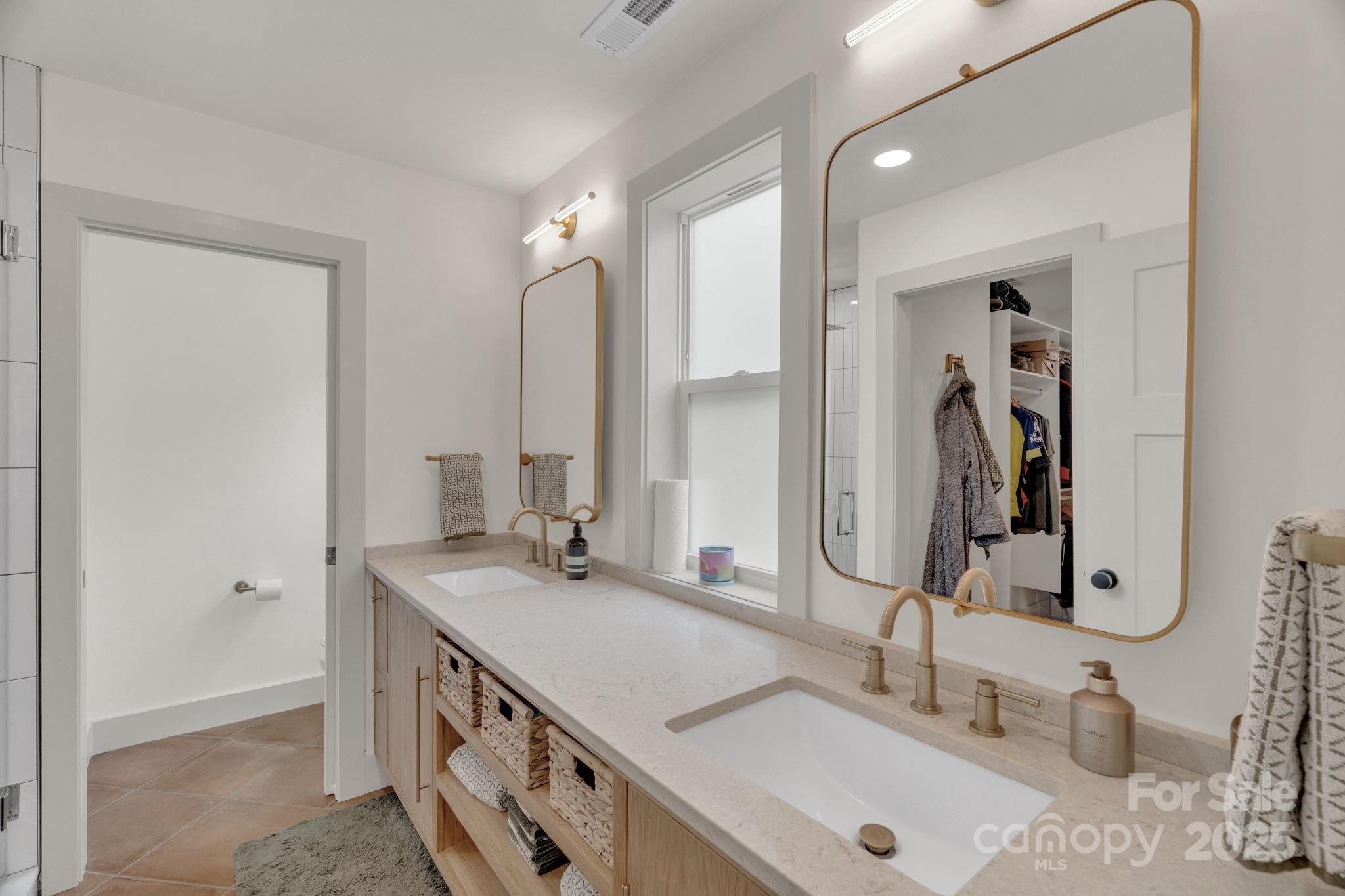 30 Spaulding Road Candler, NC 28715 - Photo 12 of 30 a bathroom with double vanity sink and a mirror