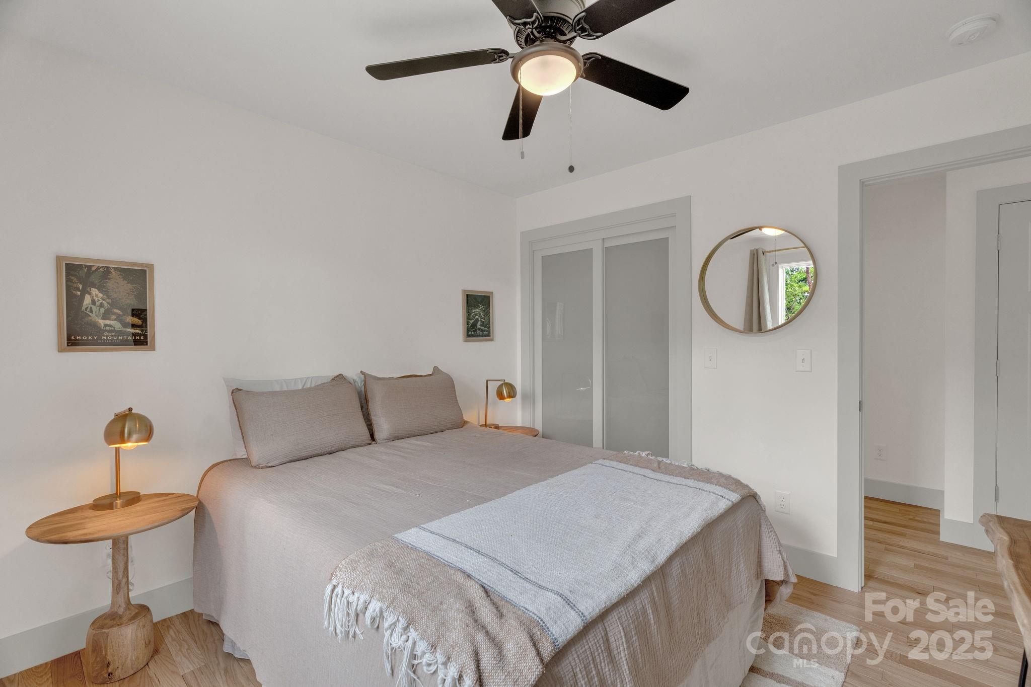 30 Spaulding Road Candler, NC 28715 - Photo 17 of 30 a bedroom with a bed and a chandelier