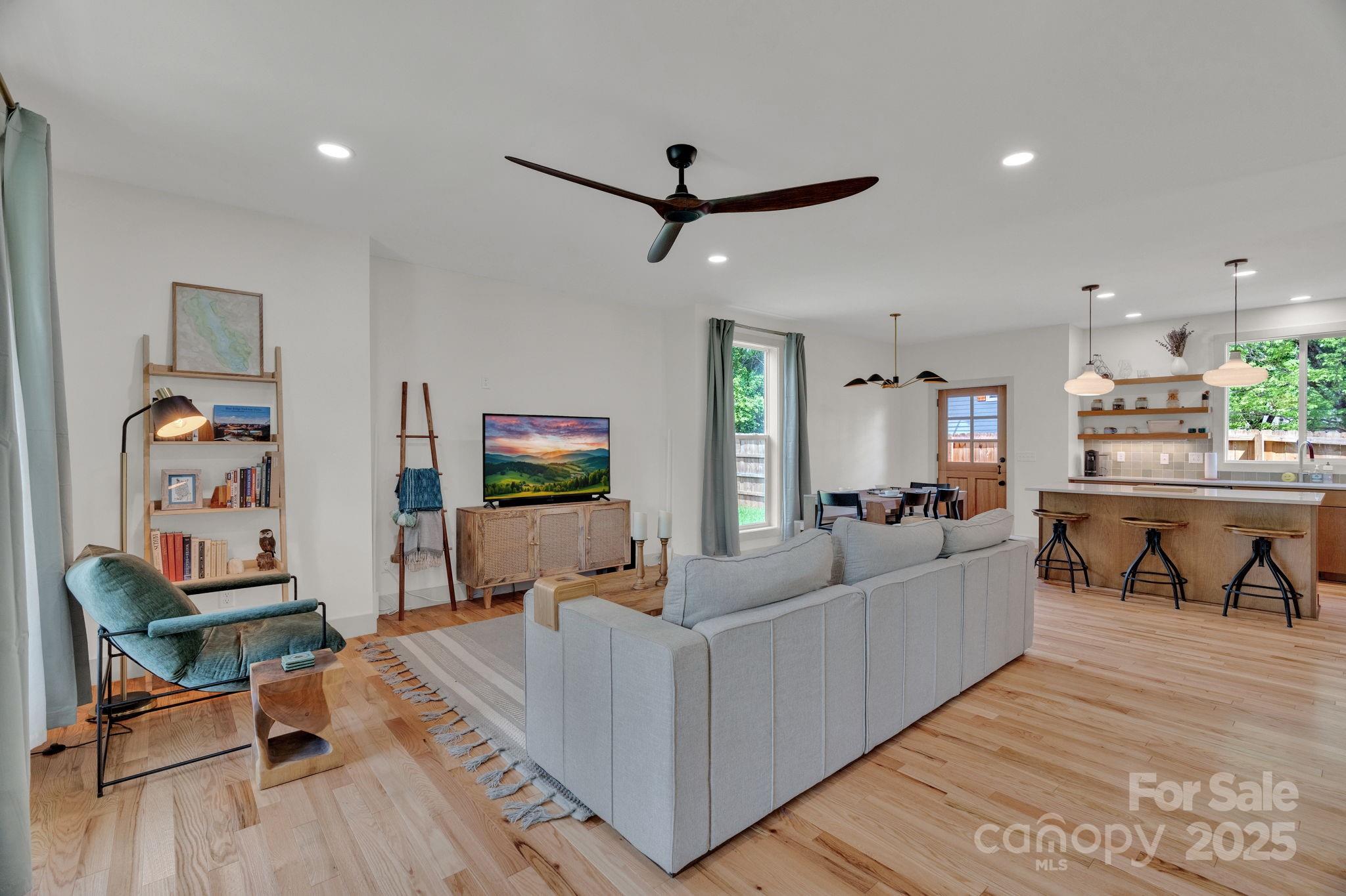 30 Spaulding Road Candler, NC 28715 - Photo 4 of 30 a living room with furniture and a flat screen tv with kitchen view