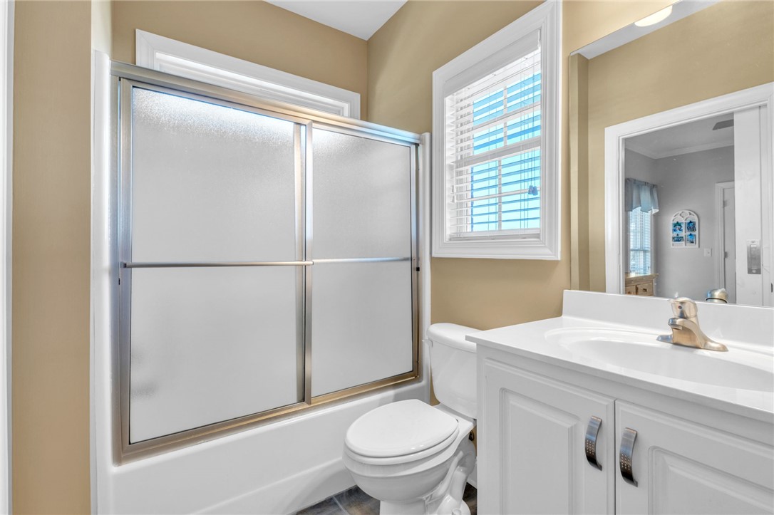648 Mountain View Road Williamston, SC 29697 - Photo 24 of 42 A window-lit bathroom offers a full shower-tub combination and ample vanity space.