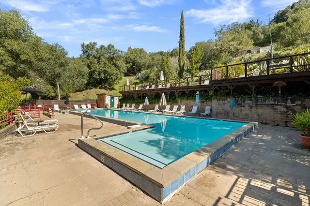 a view of swimming pool with chairs