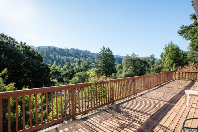 a view of balcony with wooden floor and fence