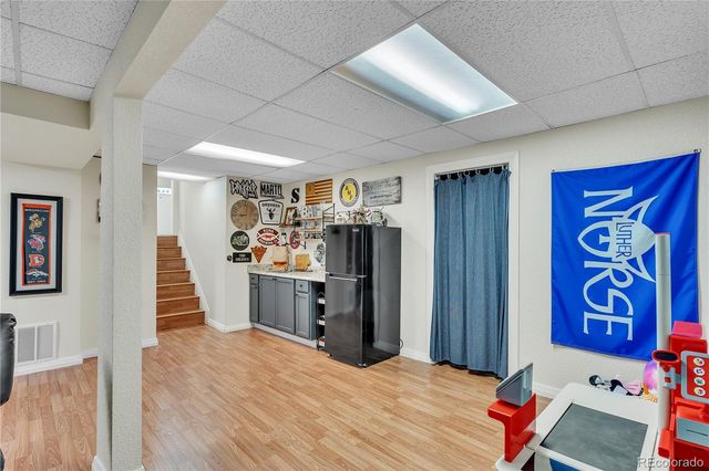 a bedroom with a bed and a refrigerator