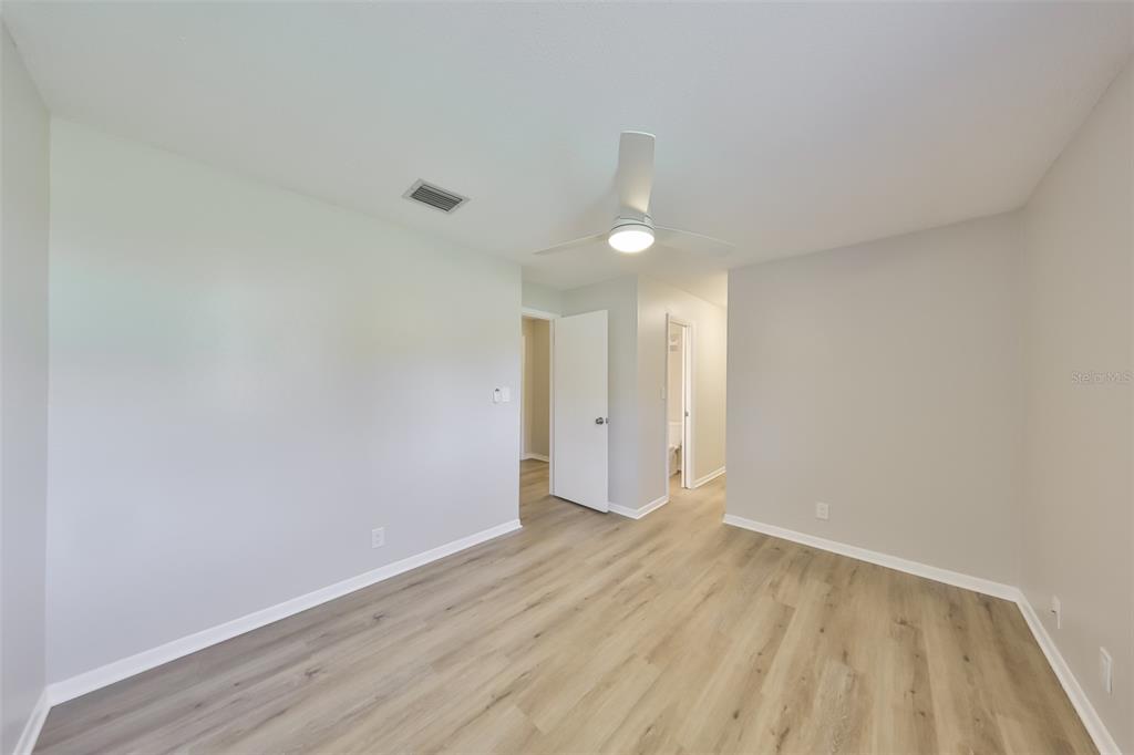 8616 Palm Lane Temple Terrace, FL 33637 - Photo 23 of 30 a view of an empty room and wooden floor