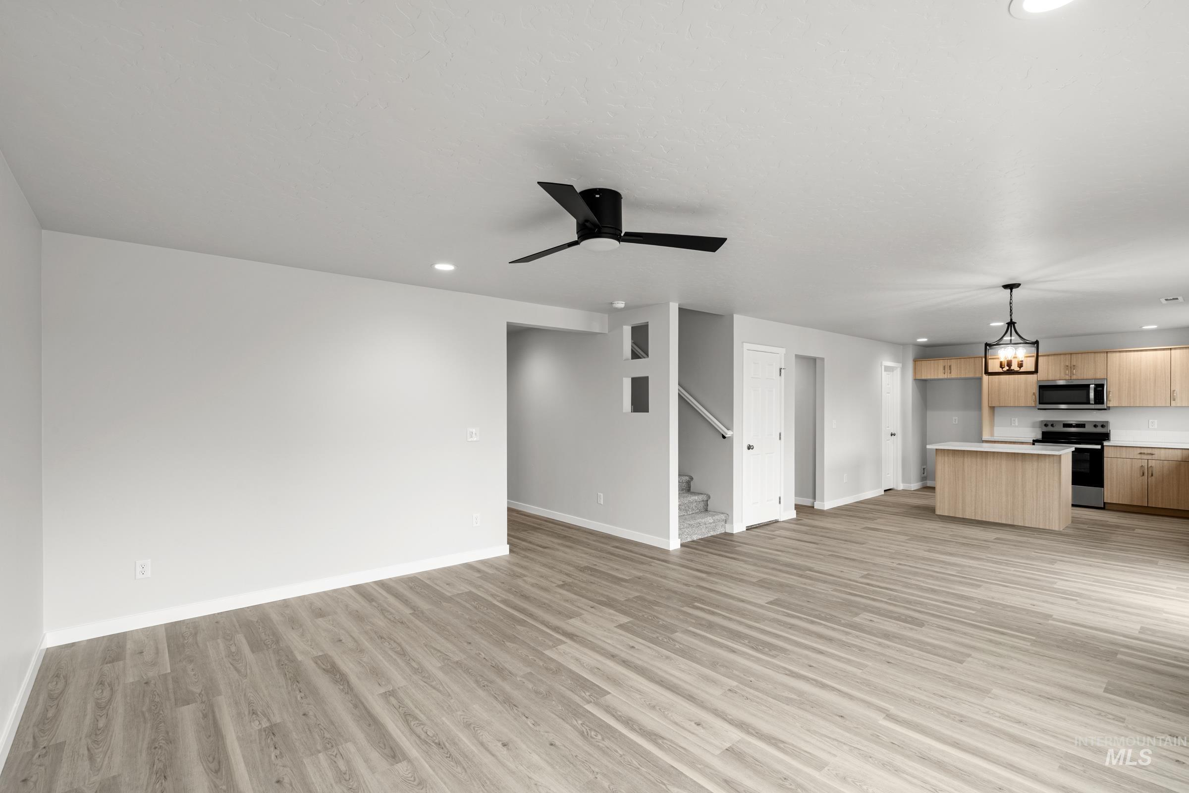 14056 Shiny Spruce Street Caldwell, ID 83607 - Photo 9 of 25 Spacious living area featuring light wood-finish flooring, recessed lighting, and a contemporary ceiling fan