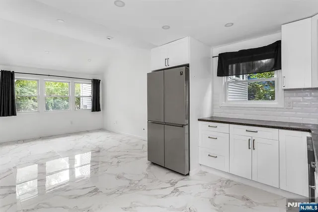 a kitchen with a refrigerator and a sink