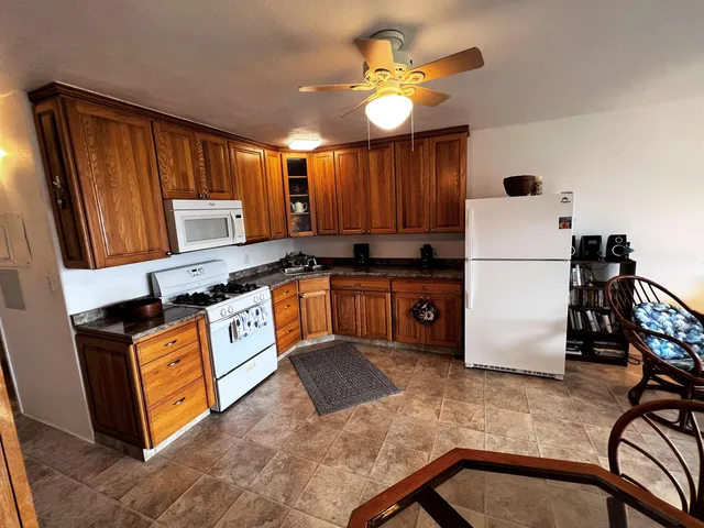 a kitchen with stainless steel appliances granite countertop a stove a sink dishwasher and a refrigerator