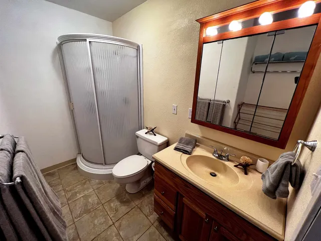 a bathroom with a sink toilet and shower