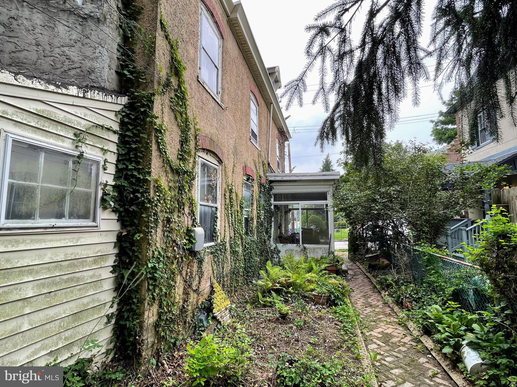 24 Westview Street Philadelphia, PA 19119 - Photo 11 of 13 a view of backyard of white apartments with large tree