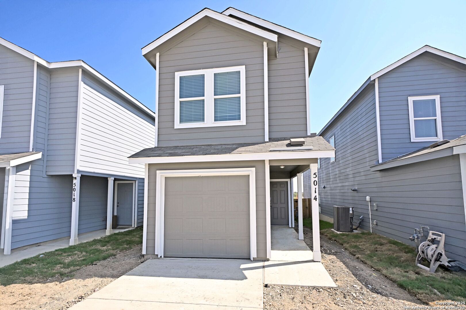 a front view of a house with a garage