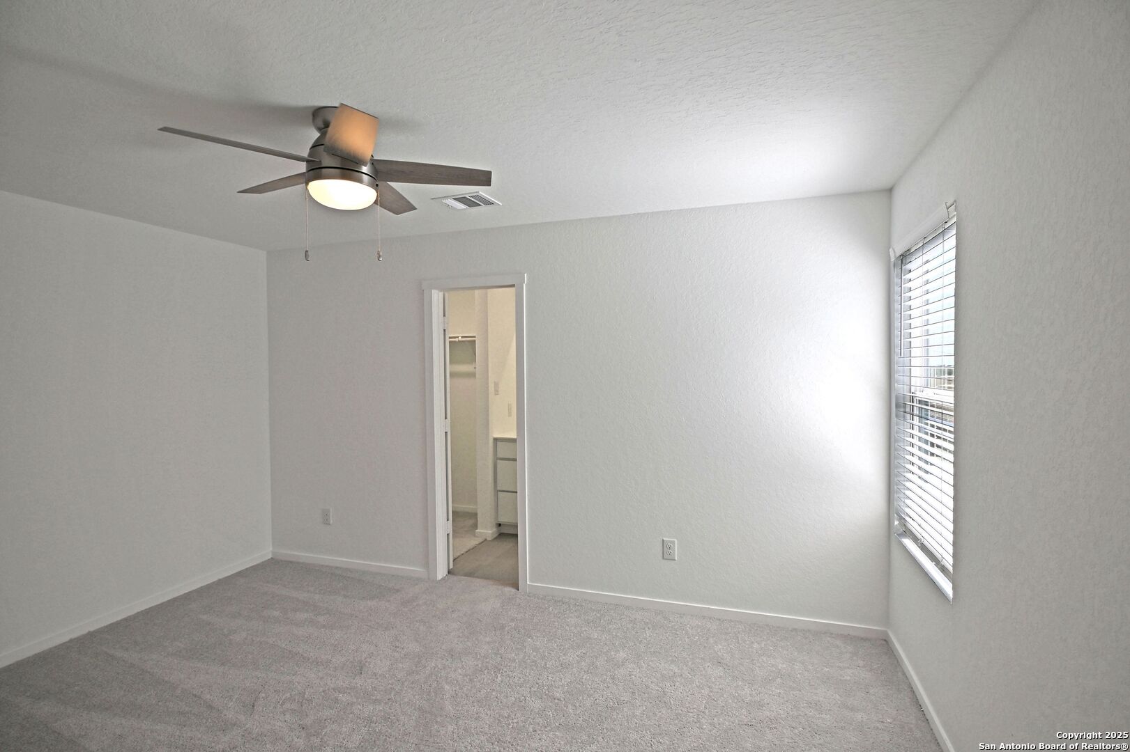 5014 Winecup Cove Converse, TX 78109 - Photo 13 of 25 an empty room with windows and fan