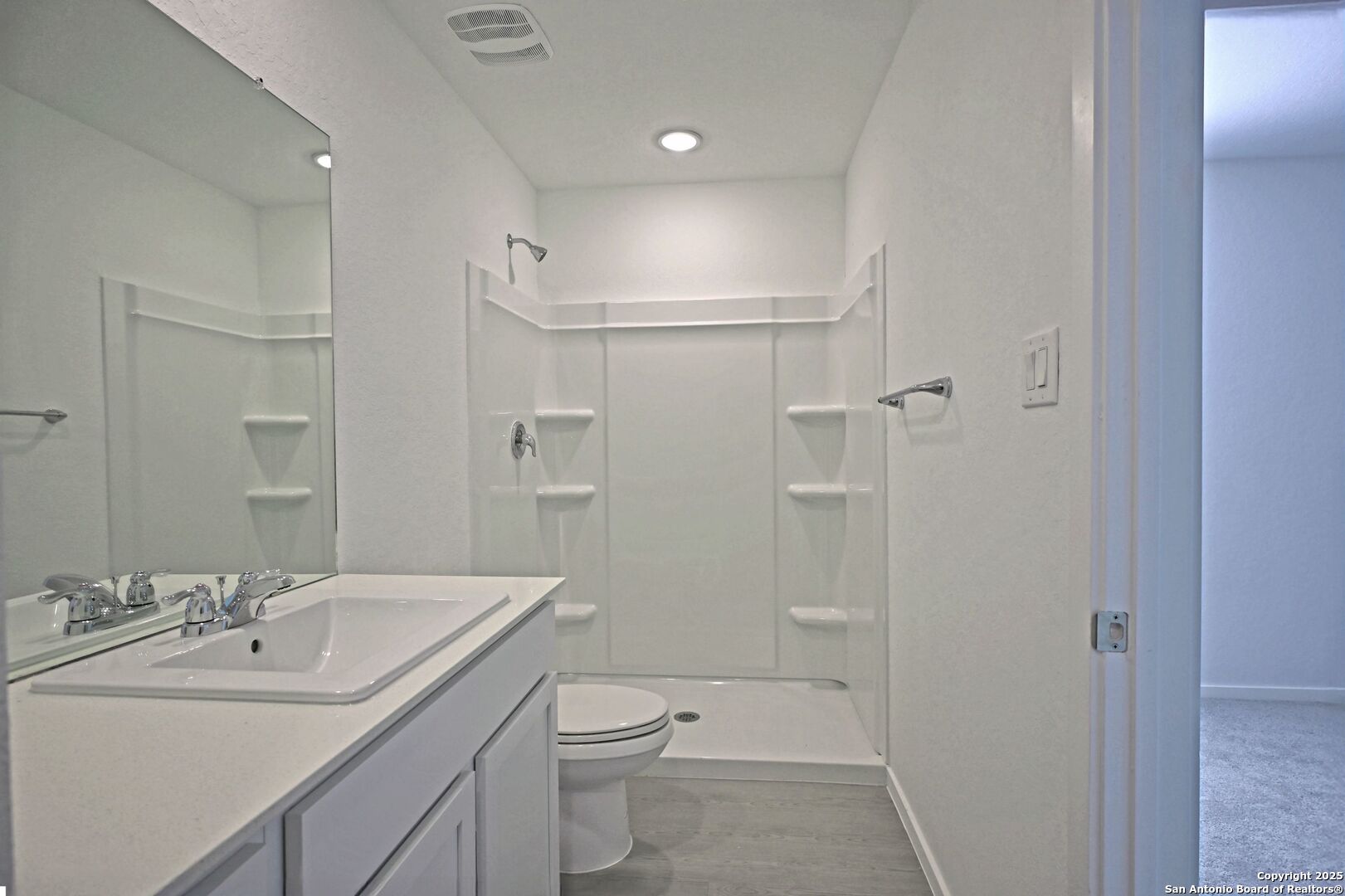 5014 Winecup Cove Converse, TX 78109 - Photo 16 of 25 a bathroom with a sink toilet vanity and shower