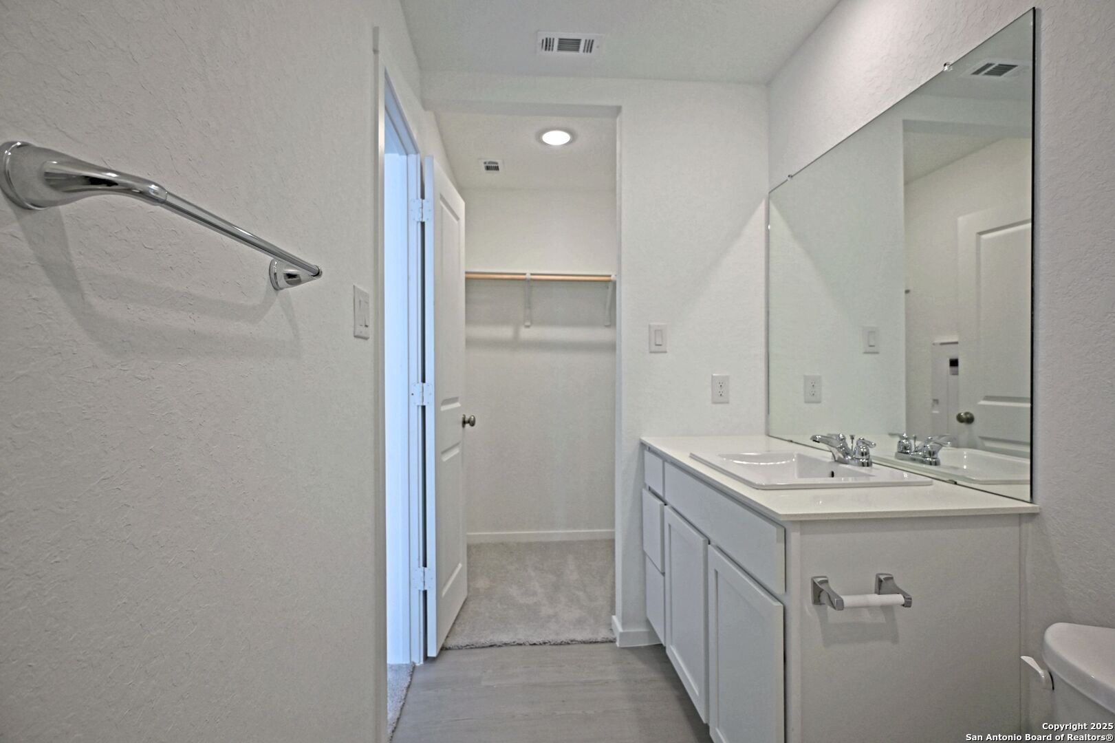 5014 Winecup Cove Converse, TX 78109 - Photo 17 of 25 a bathroom with a double vanity sink and mirror with toilet