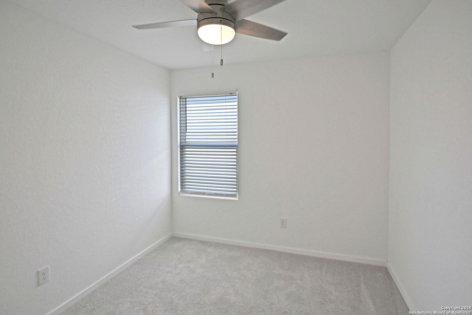 5014 Winecup Cove Converse, TX 78109 - Photo 21 of 25 an empty room with a window and a fan